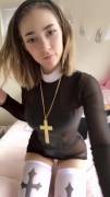 Pious girl with a cross shows her tits and pussy