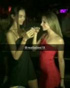 Two drunk women kissing