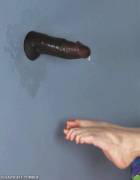 Abandoned in a glory hole, her feet catch the cum