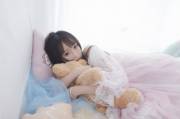 A baby sleeping with her teddy