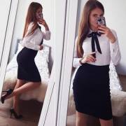 Ariadna in a black pencil skirt and shirt
