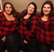 Three obese and overweight sexy women smiling dressed in red and black
