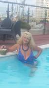 Blonde MILF and her massive tits in the pool