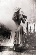 Annie Oakley shooting over her shoulder using a hand mirror, 1888
