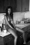 Sitting topless on the kitchen counter.