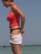 Pulling on her tight shorts on the beach
