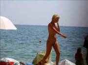 Naked blonde on public beach