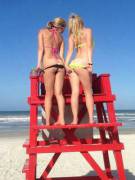 Two girls mooning on the beach