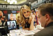 Jillian Janson signs autographs for fans at the AVN Adult Entertainment Expo in Las Vegas.