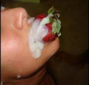 Something different- a strawberry stuck in her mouth, covered with cum