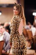 Cute poker player loses bet; has to dress up in full catsuit with ears and collar. 