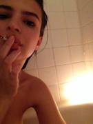 Emily Ratajkowski smoking nude in the bathtub.