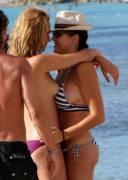 French actress and singer Nora Arnezeder topless and making out with some chick on a beach.