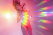 Girl covered in rainbow lens flare
