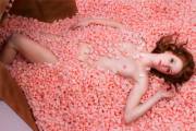 Pretty pink nipples peeking out from a pile of pink packing peanuts