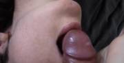 She happily strokes his load of cum into her open mouth.