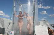 Two ladies give a show in Teppy's endless shower at Burning Man