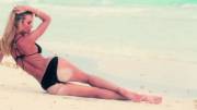 Candice Swanepoel in black, cheeky bikini seductively pulls her legs closer [gif]