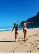 Two girls frolicking on beach