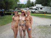 Nude girls on a camp ground, posing for the camera, at Nudes-A-Poppin' 2009