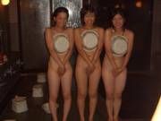 Trio concealing their modesty in a bathhouse