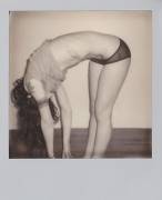 Bent over with Polaroid Camera