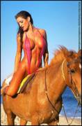 Jena Elrod, pink sling, astride a majestic horse.