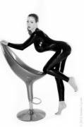 Jordan Carver stretches out a latex suit (3-picture morph sequence)