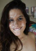Pretty girl smiling covered with jizz after facial