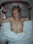 An incredible freckled specimen cuffed to her bed
