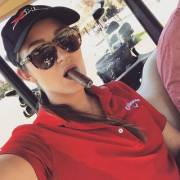 Dani Daniels smoking a cigar on the golf course