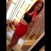 Slim redhead in a tight skirt