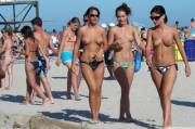Topless brunette chicks walking on the beach