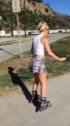Chick rollerblading onto the beach [gif]