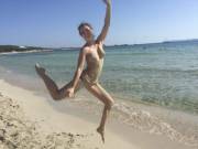 Jumping for joy while covered in sand