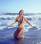 Carrie Fisher wearing a metal bikini on the beach in 1983