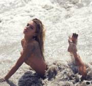 Stella Maxwell enjoying the surf in a no piece. I'm sure the surf is enjoying it too.