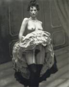Lifting her petticoats. 1900s