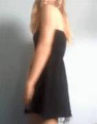 [GIF] Girl in black dress teasing and revealing strap-on