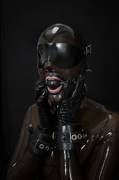 Collared, gagged and hooded in transparent rubber