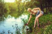 Blonde with tress takes water from the lake