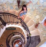 Hitomi Tanaka posing in a rocky stairwell