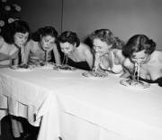 Broadway show girls compete in a hands-free spaghetti-eating contest. 1948 [xPost /r/HistoryPorn]