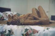 Girl on bed covered in chocolate