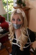 Adorable girl with duct taped mouth