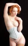 Topless ginger wearing a corset
