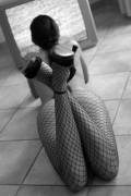 kicking her fishnetted legs up
