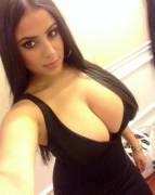 Stunning raven-haired selfie showing off her little black dress and not-so-little breasts