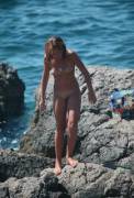 Girl walks on the rocky Crimean beach