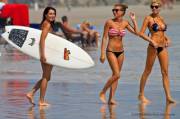 Surfer girl passes bikini babes